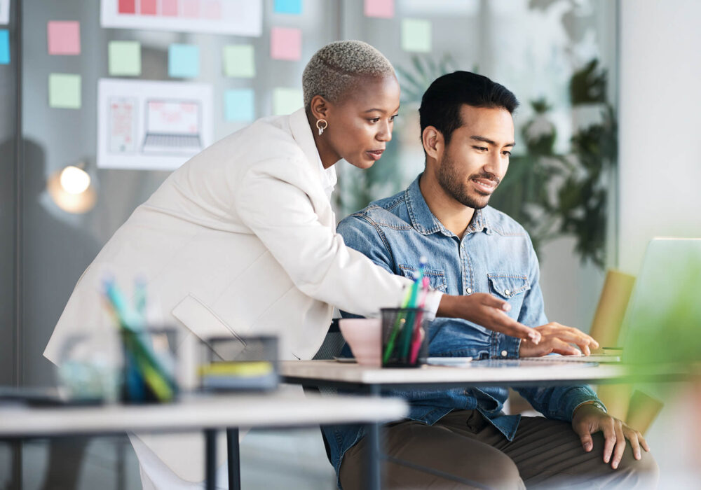 Two people looking at a computer