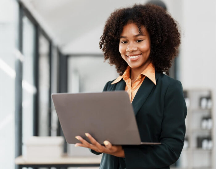 Woman smiling holding her laptop